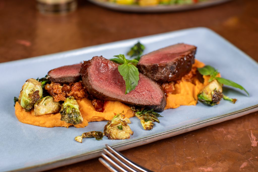 BBQ Wapiti Elk with crispy chorizo brussels sprouts and sweet potato purée.