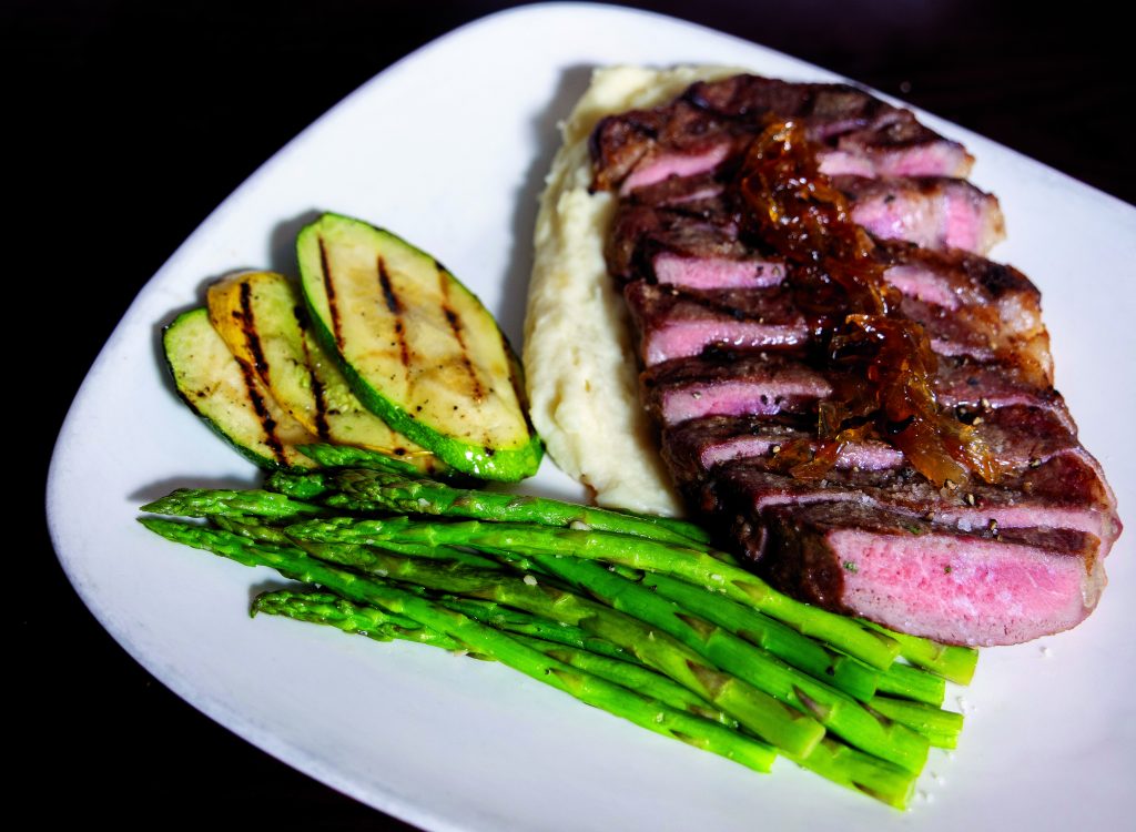 12-oz ribeye with sauteed vegetables and choice of sides.
