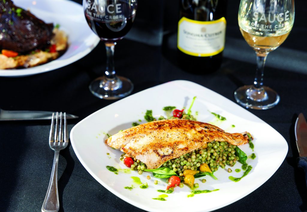 Lemon pepper branzini with pesto couscous and asparagus.