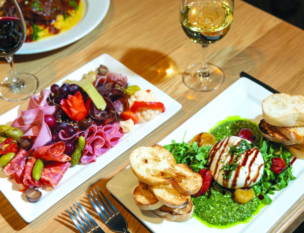 Italian Salumi Board with assorted sliced meats, olives, grapes, pickled veggies and the caprese with burrata, pesto, arugula, slow-roasted tomato, balsamic glaze and grilled ciabatta.