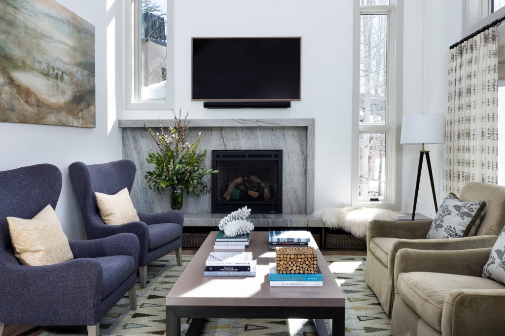 The living room now includes asymmetrical windows, in order to bring intention to the offset fireplace.